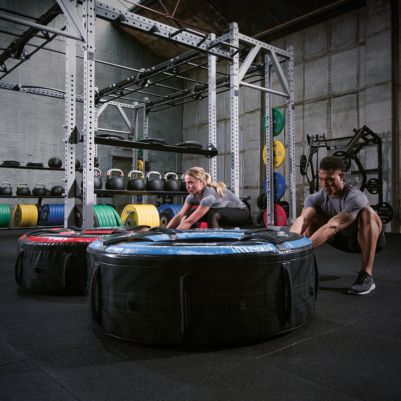 Exercisers pulling flip tires during workout