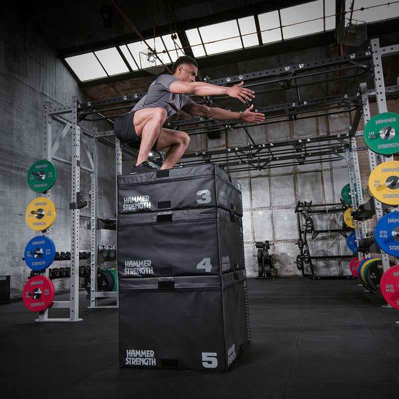 Man jumping on stacked Hammer Strength Plyo Box in gym